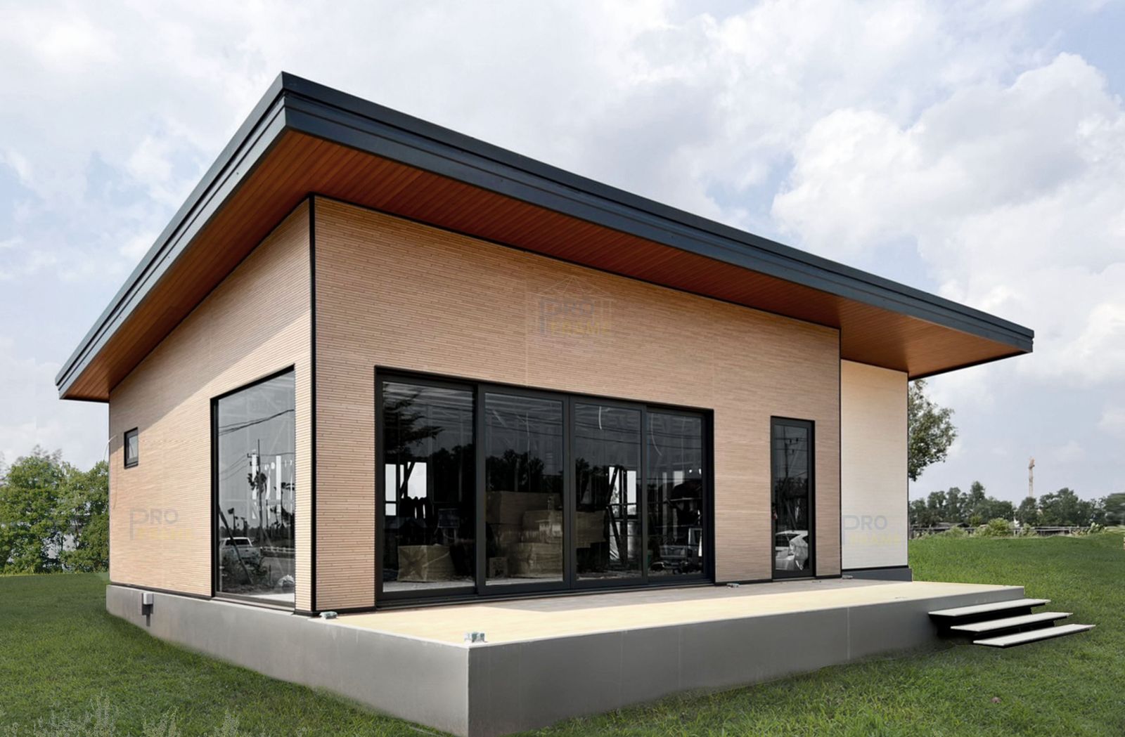 The finished sales gallery: wood-grain Nichiha walls and black-framed glass doors on a raised floor
