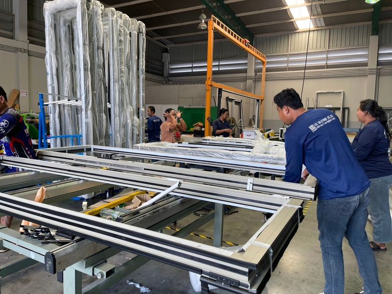 The factory team assembling aluminium frames at the workbench